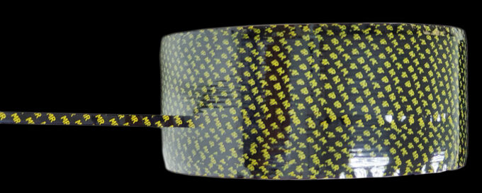 Close-up of a patterned mesh-reinforced tape roll with a narrow slit strip