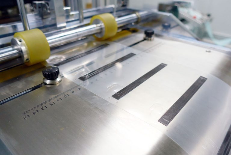 Close-up of the MATSAVE flatbed die-cut platform with clear film and steel rule dies