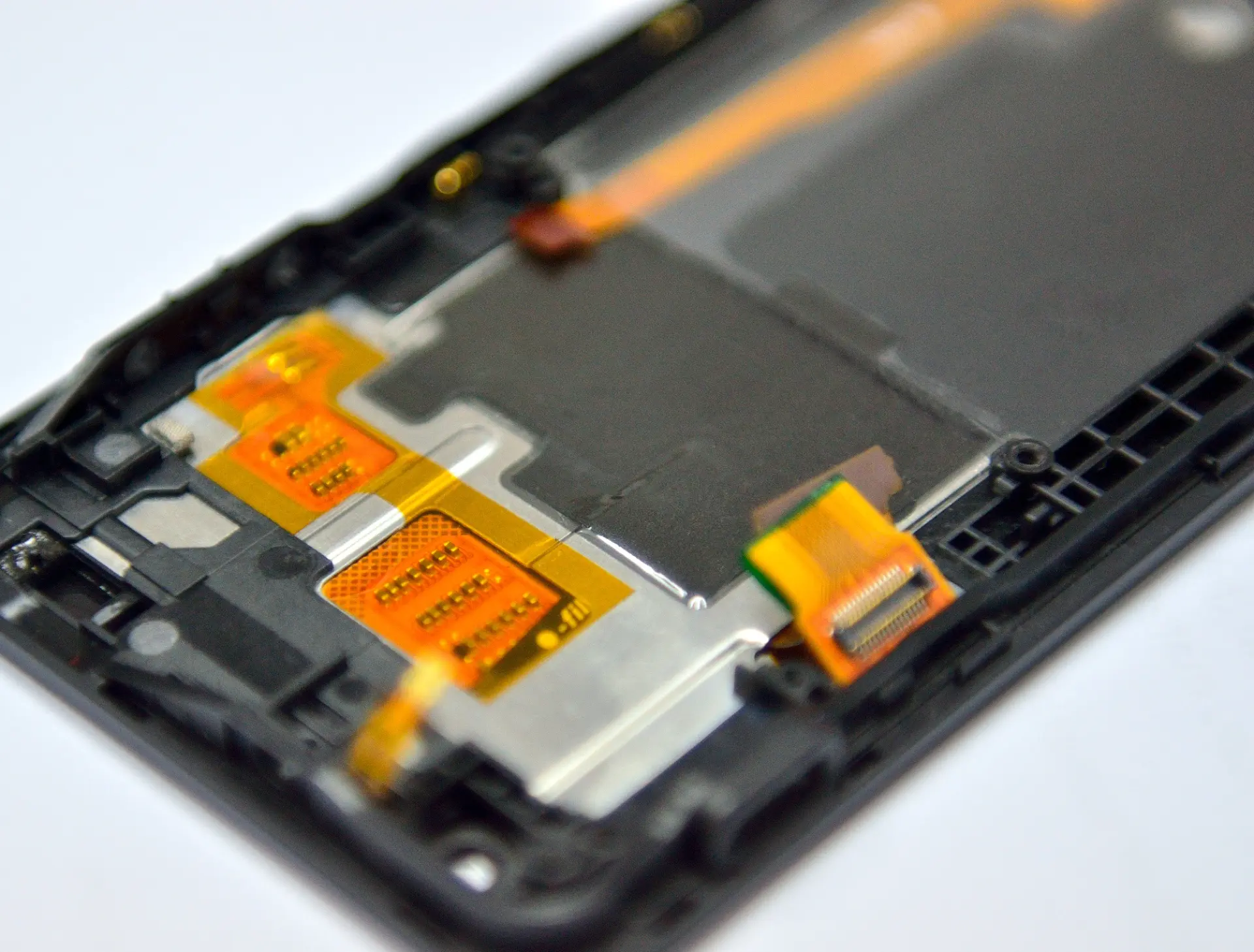 Smartphone frame assembly with die-cut adhesive layers and flexible printed circuits
