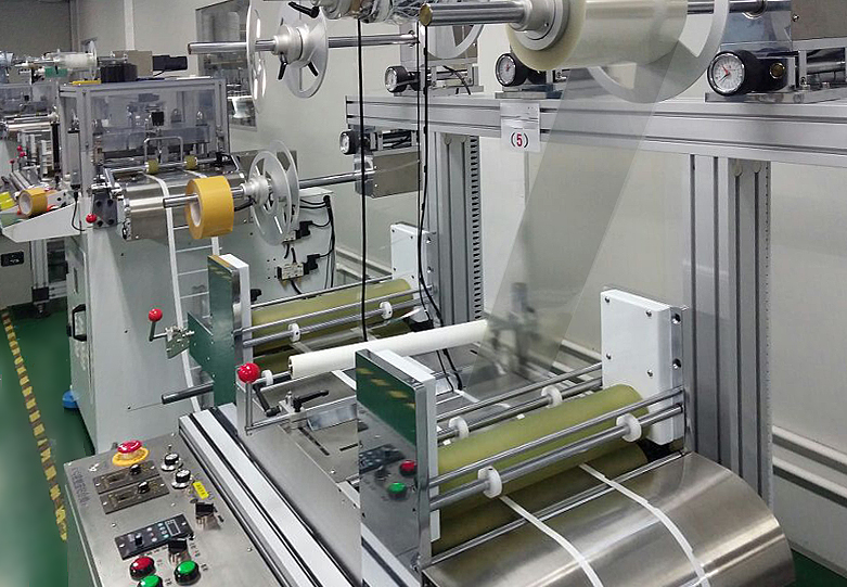 Lamination line feeding carrier tape and release liner webs through guide rollers