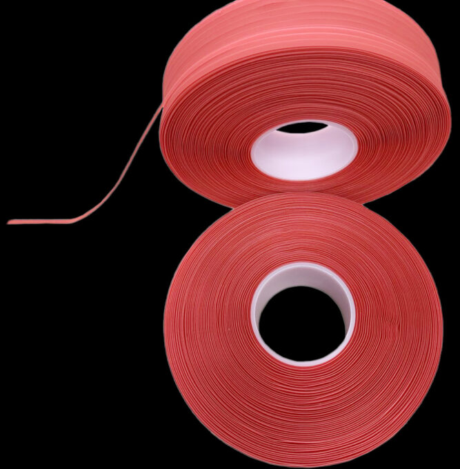 Two narrow-width spooled tape reels wound in long continuous lengths