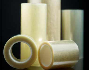 Close-up of siliconised release liner rolls on plastic cores