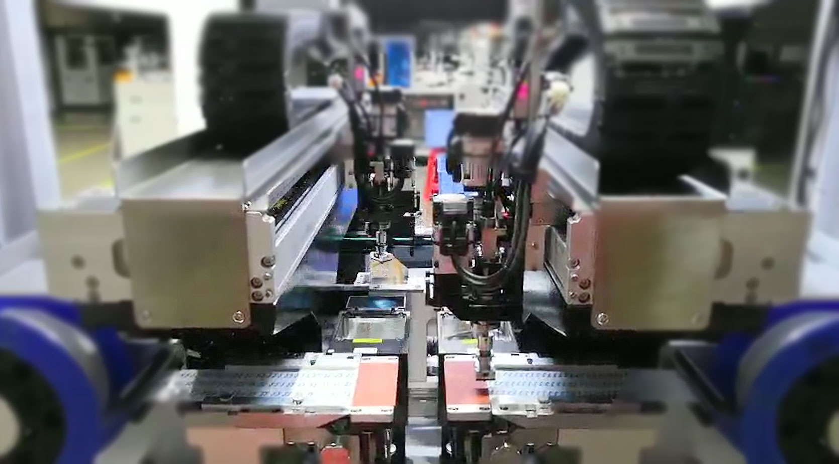 Close-up of vision-guided placement heads assembling die-cut parts onto carrier strips